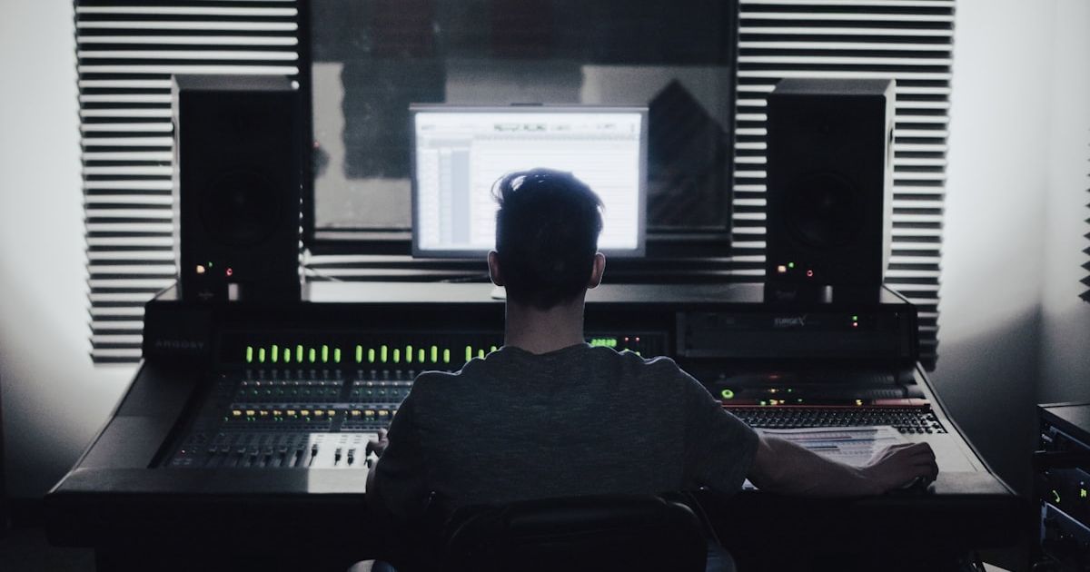 man sitting in front of computer setup